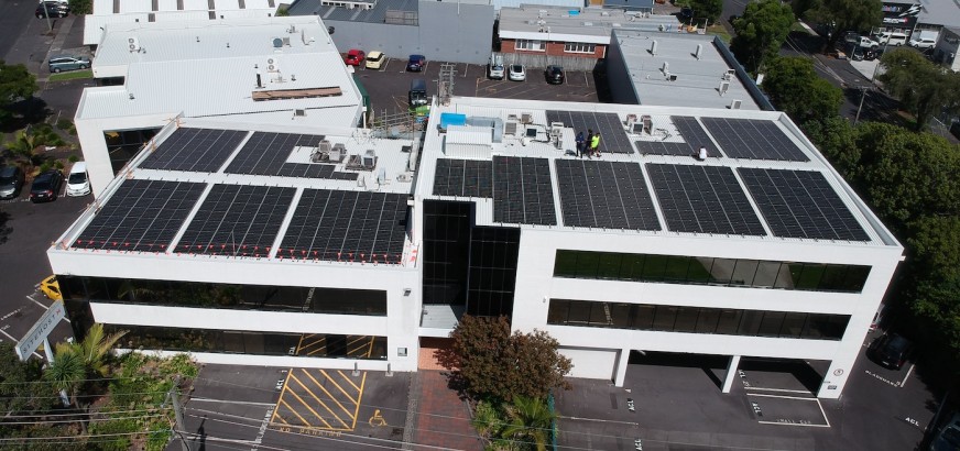 SiteHost building roof with workers installing hundreds of new solar panels.