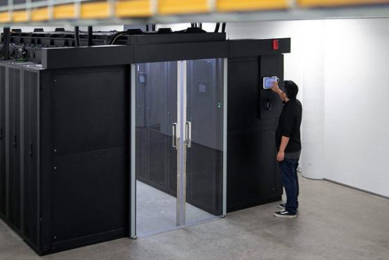 SiteHost team member using data centre touchscreen controls.